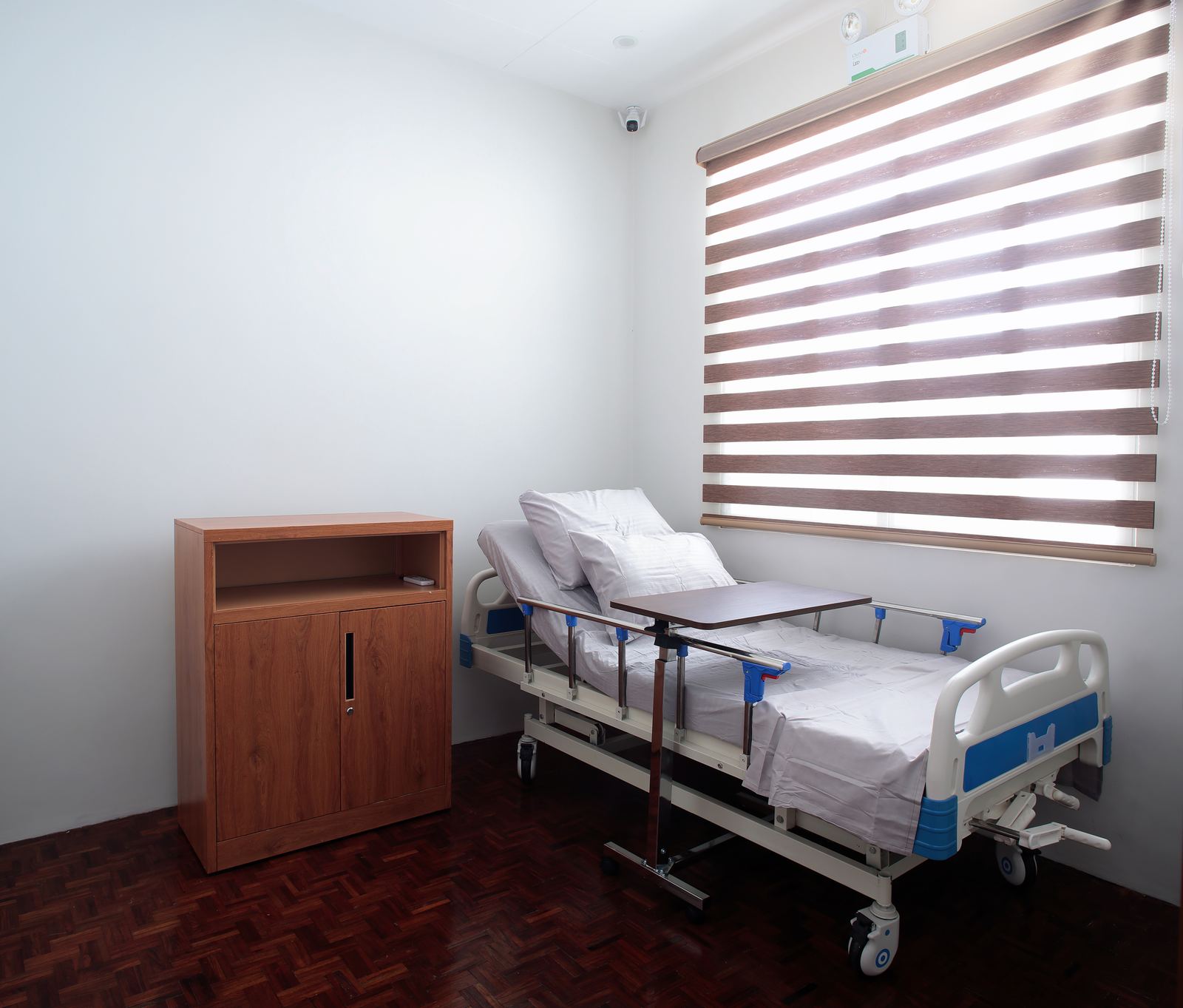 Private resident room with warm wooden flooring